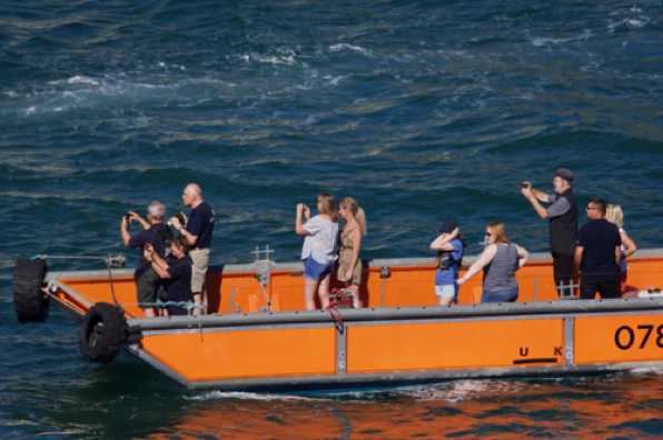 09 July 2022 - 16-56-44
Spectators aboard one of the builder's boat get a good view of the new arrival.
---------------------
Dart RNLI new Lifeboat arrives